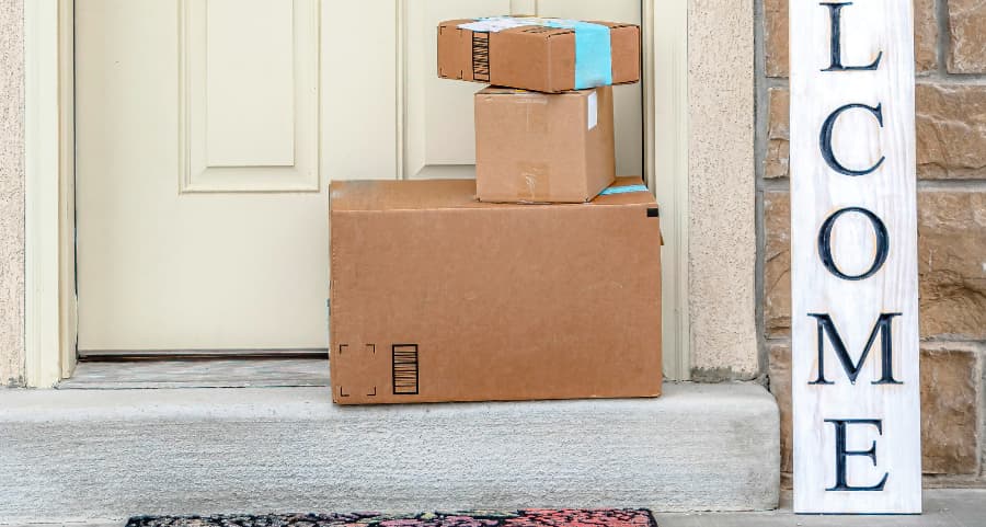 Boxes by the door of a residence with a welcome sign in Nashville